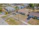 This aerial view showcases a cozy home, palm tree, a long driveway, and fenced yard at 6702 49Th N Ave, St Petersburg, FL 33709