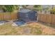 Backyard features a storage shed surrounded by grass and wood fencing at 6702 49Th N Ave, St Petersburg, FL 33709