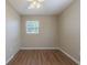 This bedroom features updated flooring, neutral paint, ceiling fan, and a window allowing natural light at 6702 49Th N Ave, St Petersburg, FL 33709