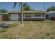 Charming single-story home featuring a one car garage and well-maintained front yard with a mature palm tree at 6702 49Th N Ave, St Petersburg, FL 33709