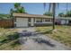 Charming single-story home featuring an attached garage and a well-manicured front yard at 6702 49Th N Ave, St Petersburg, FL 33709