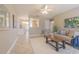 Inviting living room featuring neutral decor, a ceiling fan, a plush rug, and tile flooring throughout at 6702 49Th N Ave, St Petersburg, FL 33709