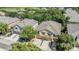 Aerial view of two-story home with mature trees, large driveway, and a front-facing garage at 6736 Breezy Palm Dr, Riverview, FL 33578