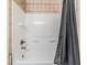Bathroom features a clean white tiled shower/tub combo and sleek fixtures at 6736 Breezy Palm Dr, Riverview, FL 33578