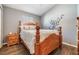 Cozy bedroom with wood floors, warm wood furnishings, and soft natural light from the window at 6736 Breezy Palm Dr, Riverview, FL 33578