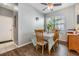 Cozy dining area featuring wood floors, a ceiling fan, and natural light from a nearby window at 6736 Breezy Palm Dr, Riverview, FL 33578