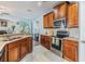 Well-equipped kitchen boasts wood cabinets, stainless steel appliances, and granite countertops at 6736 Breezy Palm Dr, Riverview, FL 33578