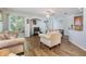 Bright living room with hardwood floors and sliding glass doors to the backyard at 6736 Breezy Palm Dr, Riverview, FL 33578