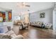 Bright living room with hardwood floors, neutral paint, and an open floor plan at 6736 Breezy Palm Dr, Riverview, FL 33578