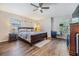 Spacious bedroom with wood floors, ceiling fan, and a bright, airy feel at 6736 Breezy Palm Dr, Riverview, FL 33578