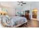 Bedroom with wood floors, windows with blinds, and access to the bathroom at 6736 Breezy Palm Dr, Riverview, FL 33578
