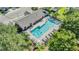 Aerial view of community pool with lounge chairs and tables at 6736 Breezy Palm Dr, Riverview, FL 33578