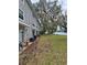 Spacious backyard of gray townhouse, featuring lake views and mature trees with spanish moss at 7168 E Bank Dr # 7168, Tampa, FL 33617