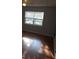 Bedroom with fan, window with blinds, and hardwood floors at 7168 E Bank Dr # 7168, Tampa, FL 33617