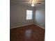 Bedroom with a ceiling fan, hardwood floors, and window with blinds at 7168 E Bank Dr # 7168, Tampa, FL 33617