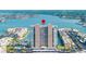 Panoramic aerial view of a waterfront condo building with pool, parking, and stunning bay views at 7300 Sun Island S Dr # 605, South Pasadena, FL 33707