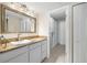 Bathroom featuring a vanity with a stylish sink, granite countertop, and a large walk-in closet at 7300 Sun Island S Dr # 605, South Pasadena, FL 33707