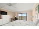 Bright bedroom with a ceiling fan, work space, and sliding door to balcony with views of the water at 7300 Sun Island S Dr # 605, South Pasadena, FL 33707