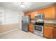 Well-equipped kitchen with stainless steel appliances and wooden cabinetry at 7300 Sun Island S Dr # 605, South Pasadena, FL 33707