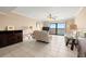 Inviting living room with tile floor, ceiling fan, comfortable seating and water views at 7300 Sun Island S Dr # 605, South Pasadena, FL 33707