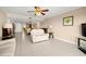 Spacious living room with tile, modern fan, and view into the dining area at 7300 Sun Island S Dr # 605, South Pasadena, FL 33707
