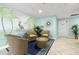 Inviting lobby area with comfortable wicker seating, tropical mural, and tile flooring at 7300 Sun Island S Dr # 605, South Pasadena, FL 33707