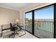 Office space with glass desk, chair, and sliding glass door leading to a balcony with beautiful water views at 7300 Sun Island S Dr # 605, South Pasadena, FL 33707