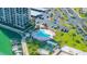 Overhead view of a community pool, hot tub, and boat docks near covered parking at 7300 Sun Island S Dr # 605, South Pasadena, FL 33707