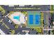 Overhead shot of a community pool and tennis courts surrounded by parking and green space at 7300 Sun Island S Dr # 605, South Pasadena, FL 33707