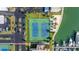 Overhead view of community tennis courts with boat docks and parking lots at 7300 Sun Island S Dr # 605, South Pasadena, FL 33707