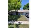 Charming single-story home featuring stone accents, well-maintained lawn, and attached one-car garage at 7317 Mitchell Ranch Rd, New Port Richey, FL 34655
