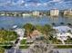 Aerial view of waterfront properties, lush trees, and a clear view of the intercoastal waterways at 761 Bay Esplanade, Clearwater Beach, FL 33767