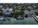 Waterfront home with mature trees and a private boat dock along the water with serene ocean views at 761 Bay Esplanade, Clearwater Beach, FL 33767