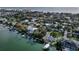 Stunning aerial view of waterfront homes with boat docks along the beach with gulf views at 761 Bay Esplanade, Clearwater Beach, FL 33767