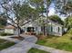 Charming home exterior with a curved driveway and well-maintained lawn and mature trees at 761 Bay Esplanade, Clearwater Beach, FL 33767