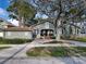 Classic home exterior with a welcoming porch, neat landscaping and a detached garage at 761 Bay Esplanade, Clearwater Beach, FL 33767