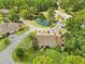 A scenic aerial view of a house near a pond and lush greenery at 7633 Piping Rock Ct # 7633, New Port Richey, FL 34654