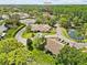 A high angle shot of the real estate property, adjacent neighborhood, and the local clubhouse at 7633 Piping Rock Ct # 7633, New Port Richey, FL 34654