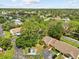 A bird's-eye view of a well-kept home with mature trees and a manicured lawn at 7633 Piping Rock Ct # 7633, New Port Richey, FL 34654