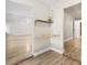 Entryway featuring stylish shelving, wood-look flooring, and a view of the mirrored wall at 7633 Piping Rock Ct # 7633, New Port Richey, FL 34654