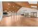 A large great room with an extensive plank floor, a platform stage, and abundant natural light at 7633 Piping Rock Ct # 7633, New Port Richey, FL 34654