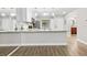 Bright kitchen featuring stainless steel appliances, an island, and wooden floors at 7633 Piping Rock Ct # 7633, New Port Richey, FL 34654