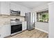 Bright kitchen featuring stainless steel appliances, white cabinetry and stone countertops at 7633 Piping Rock Ct # 7633, New Port Richey, FL 34654
