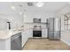 Bright kitchen featuring stainless steel appliances, an island, and wooden floors at 7633 Piping Rock Ct # 7633, New Port Richey, FL 34654