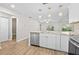 Bright kitchen featuring stainless steel appliances, an island, and wooden floors at 7633 Piping Rock Ct # 7633, New Port Richey, FL 34654