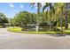 Scenic view of the pond with mature trees and a charming wooden bridge at 7633 Piping Rock Ct # 7633, New Port Richey, FL 34654