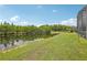 Lush backyard with pond and green lawn at 8124 Brinegar Cir, Tampa, FL 33647