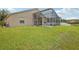 Spacious backyard featuring a screened-in pool area and lush green lawn, perfect for relaxation at 8124 Brinegar Cir, Tampa, FL 33647