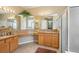 Bright bathroom featuring double sinks, granite countertops, and a glass-enclosed shower at 8124 Brinegar Cir, Tampa, FL 33647