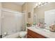 This bathroom has a tiled shower with a glass door, neutral walls and a marble vanity at 8124 Brinegar Cir, Tampa, FL 33647